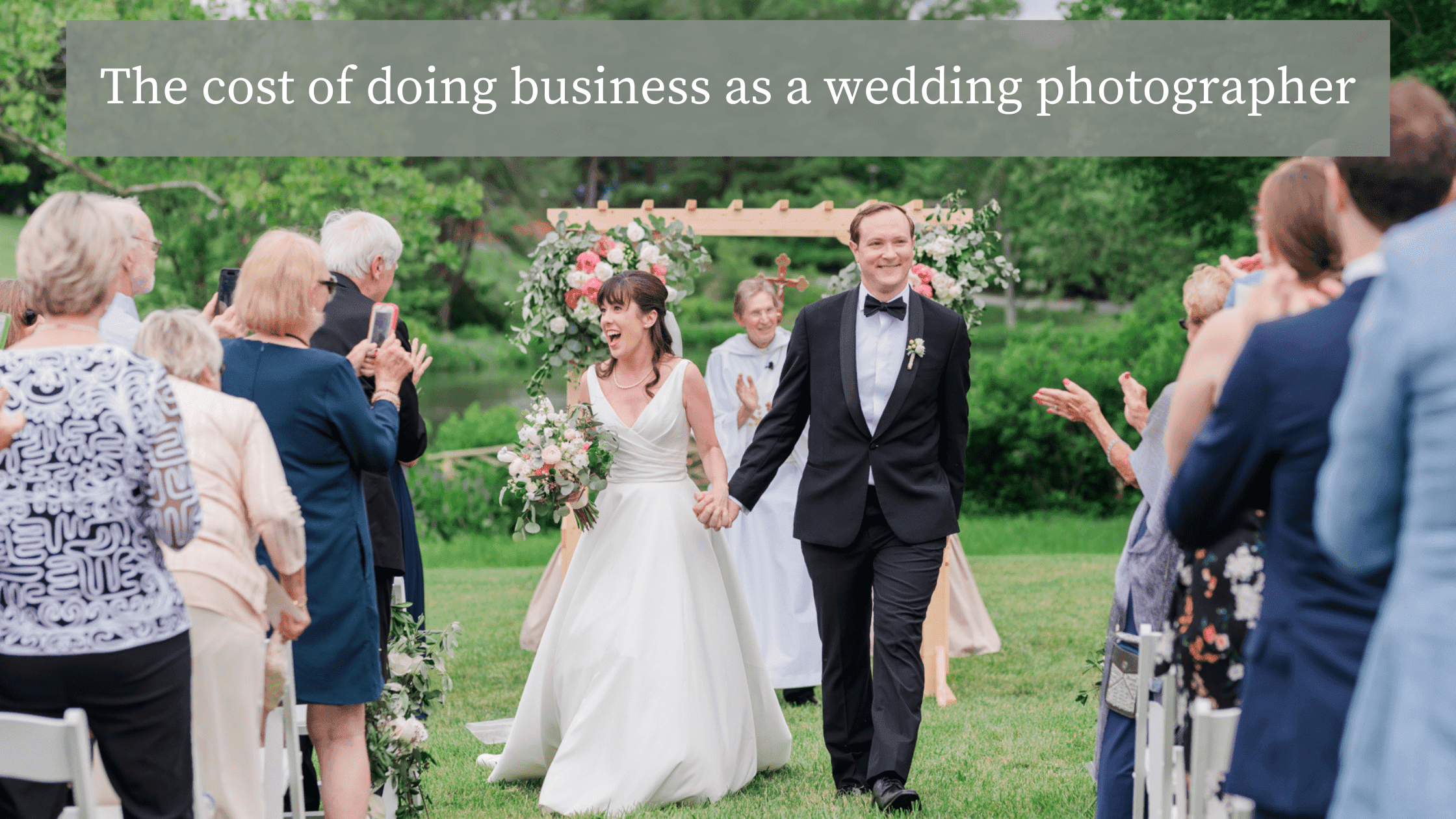 A bride and groom smile and walk back down the aisle at their sunny outdoor summer wedding after being pronounced husband and wife. Text at the top of the image reads: "The cost of doing business as a wedding photographer."