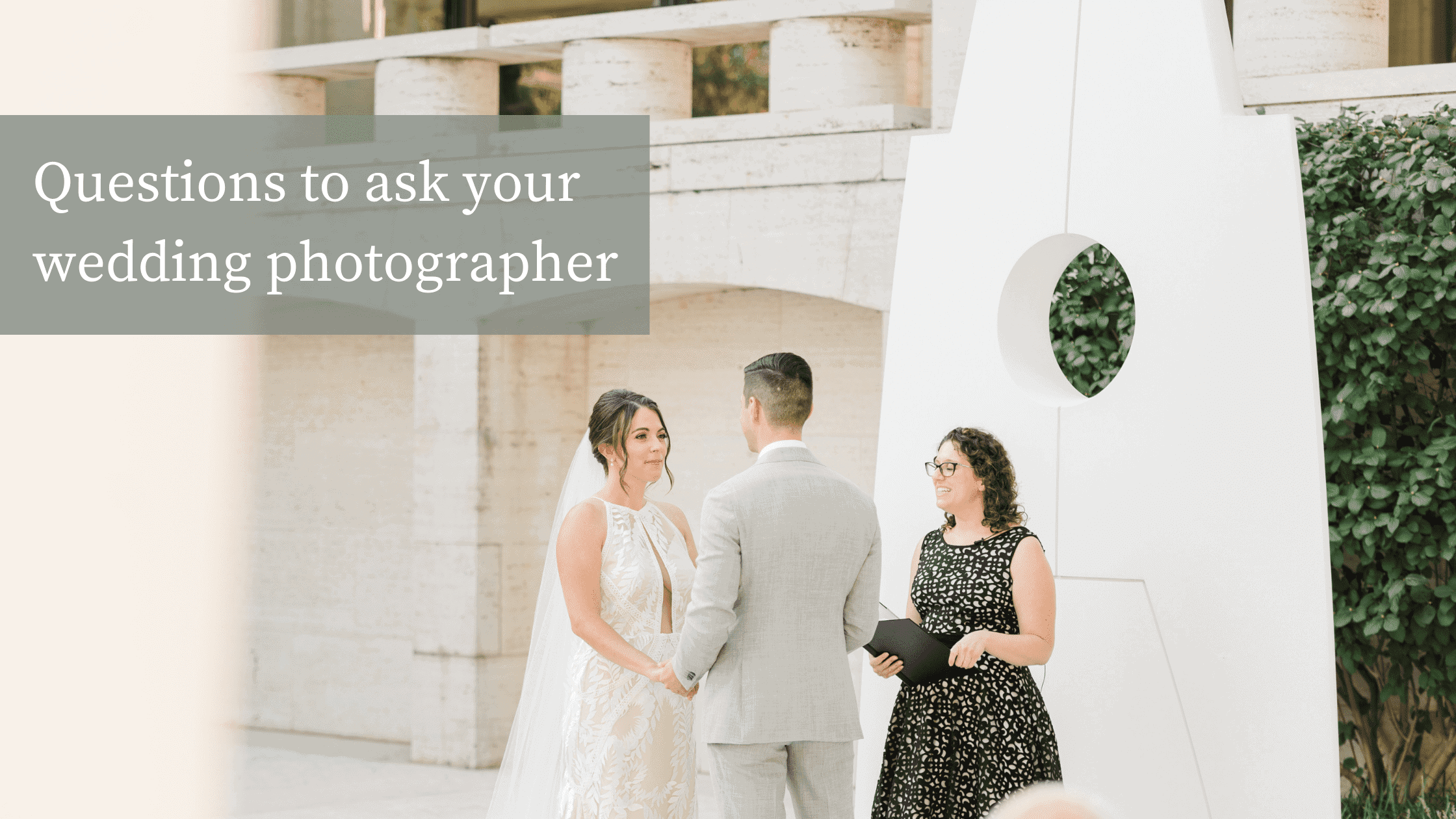 Surrounded by sunlight pouring in the beautiful white courtyard of the Kreeger Museum in Washington DC, a bride holds her partners hand and says her vows to him. The text overlay on the left reads: "Questions to ask your wedding photographer"