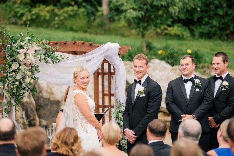 Couple smiles back at their guests during their wedding ceremony