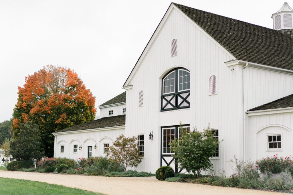 Front entrance of the white barn venue Castle Hill Cider in Keswick, Virginia, which also doubles as an engagement session location option.