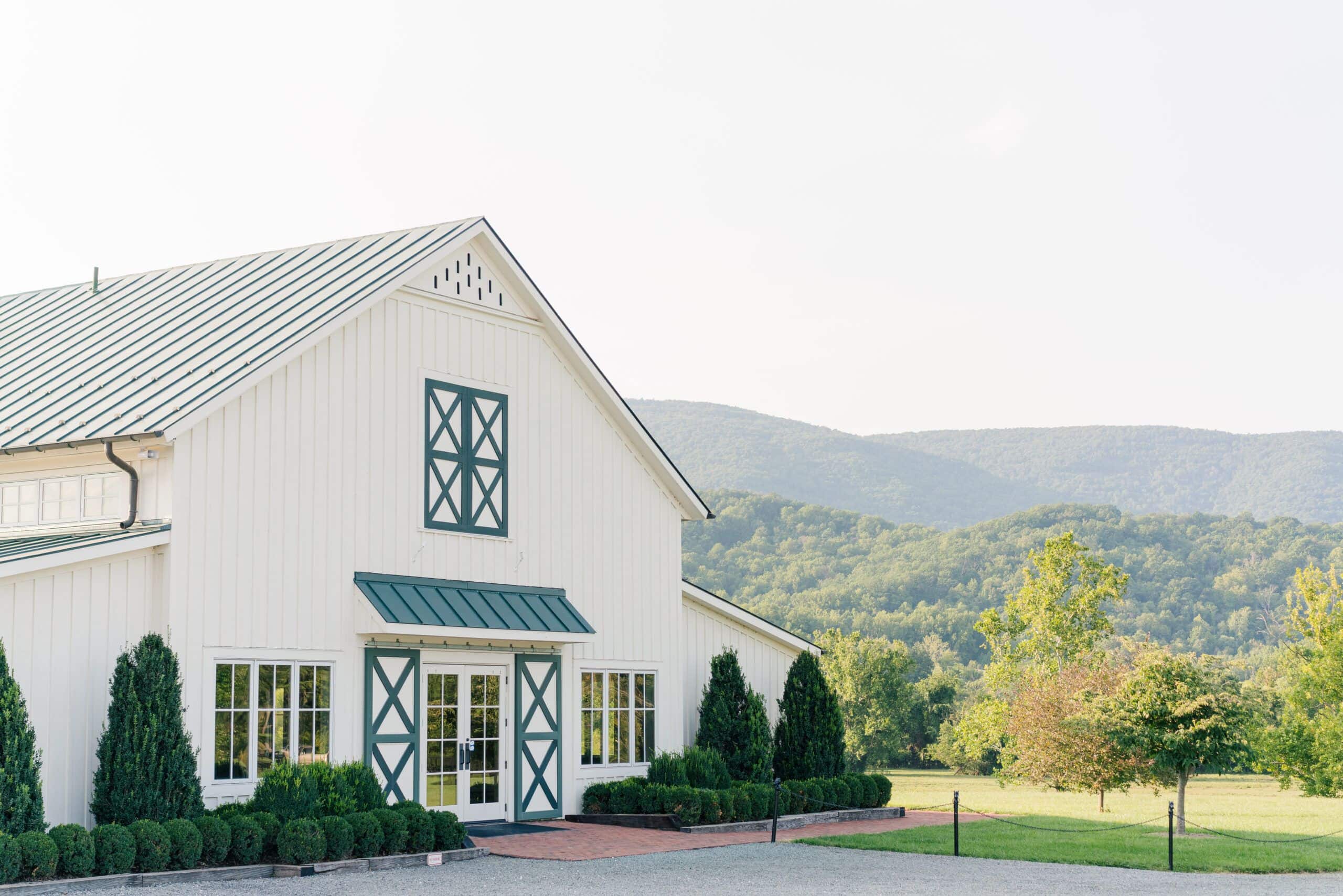 Front of the white wedding venue at King Family Vineyards weddings and events, a venue in Crozet, VA. Photograph taken by Photography by Jo, a Virginia engagement photographer.