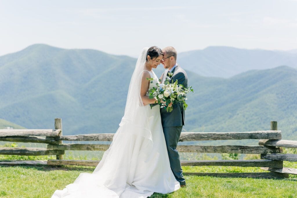 Couple sweetly embraces for their wedding photos in the mountains at Wintergreen Resort wedding at Afton mountain overlook in Roseland, VA. Photograph taken by Photography by Jo, a Virginia wedding photographer.