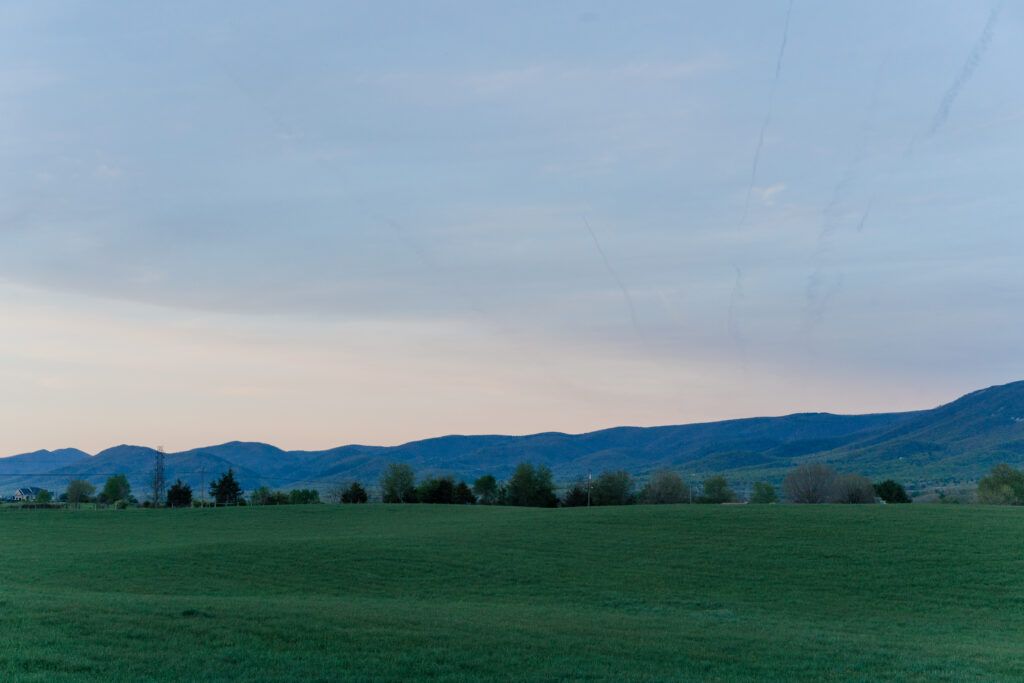 Sunset over the mountains at Sky Ridge Farm, a barn wedding venue in Waynesboro, VA, near the Blue Ridge Mountains. Photo by Wedding Phootography by Jo Mahaney, a Virginia wedding photographer.