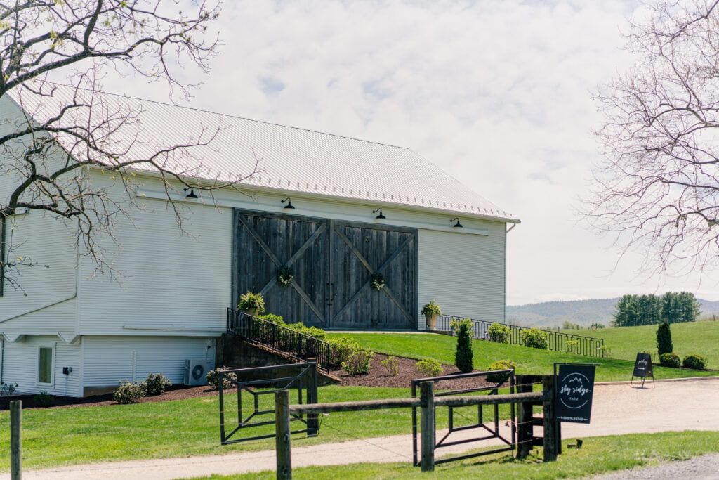 Gorgeous white barn and farm property at Sky Ridge Farm, a barn wedding venue in Waynesboro, VA, near the Blue Ridge Mountains. Photo by Wedding Phootography by Jo Mahaney, a Virginia wedding photographer.