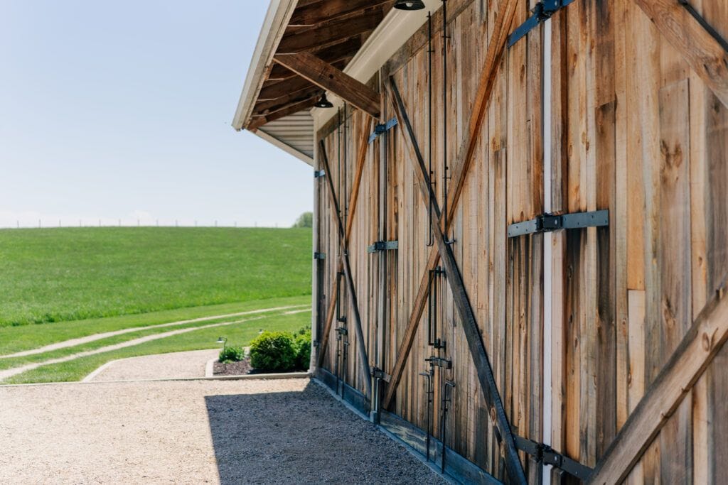 Back patio behind the barn, often used for cocktail hour at Sky Ridge Farm, a barn wedding venue in Waynesboro, VA, near the Blue Ridge Mountains. Photo by Wedding Phootography by Jo Mahaney, a Virginia wedding photographer.