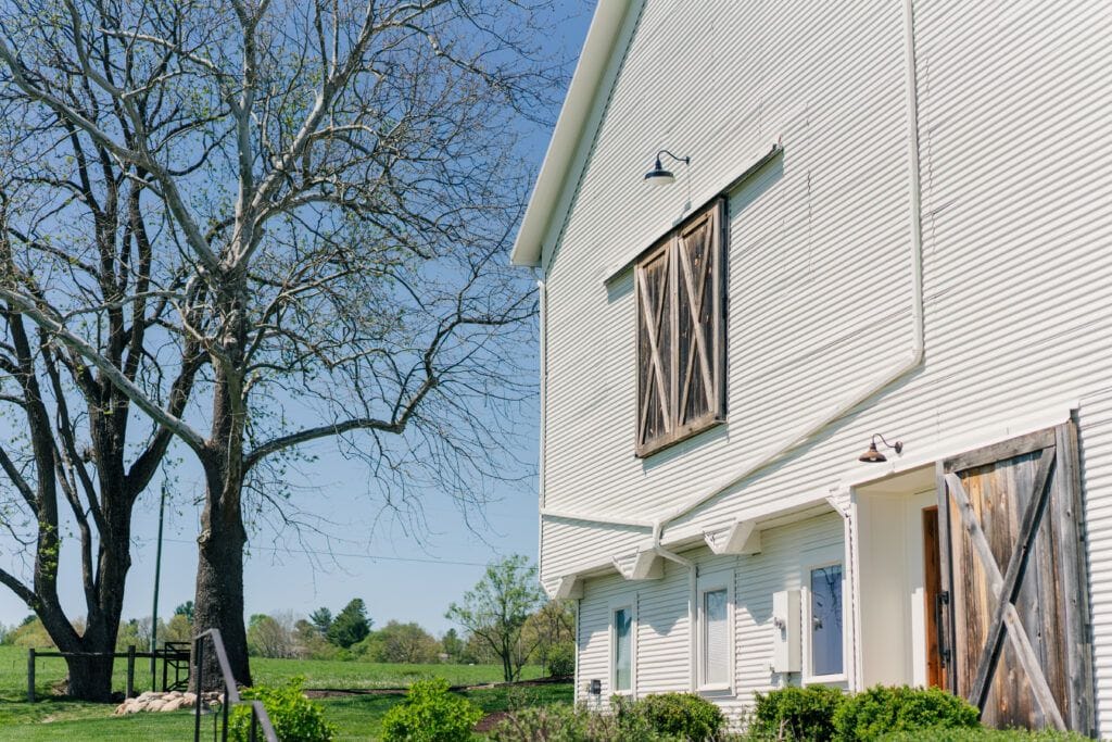 The side of the white barn at Sky Ridge Farm, a barn wedding venue in Waynesboro, VA, near the Blue Ridge Mountains. Photo by Wedding Phootography by Jo Mahaney, a Virginia wedding photographer.