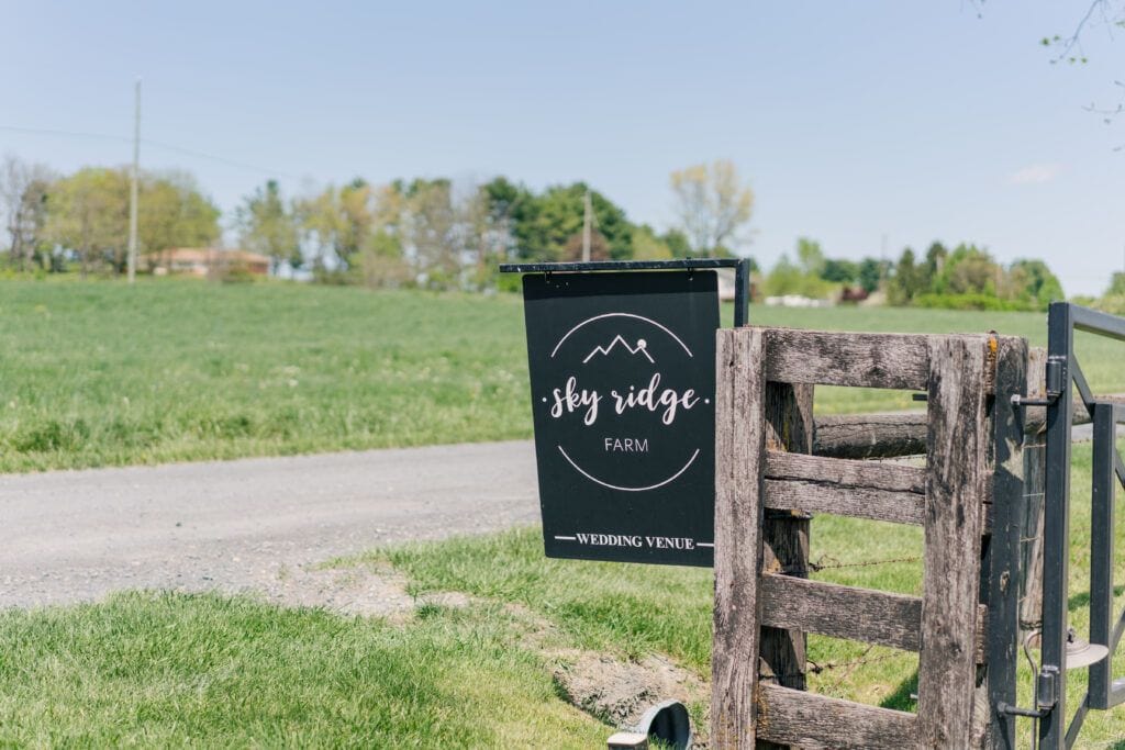 "Sky Ridge Farm" sign with venue logo outside of Waynesboro VA barn wedding venue. Photo by Wedding Phootography by Jo Mahaney, a Virginia wedding photographer.