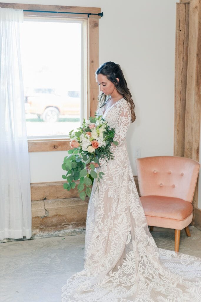 Bride dresses in bridal suite at Sky Ridge Farm, a barn wedding venue in Waynesboro, VA, near the Blue Ridge Mountains. Photo by Wedding Phootography by Jo Mahaney, a Virginia wedding photographer.
