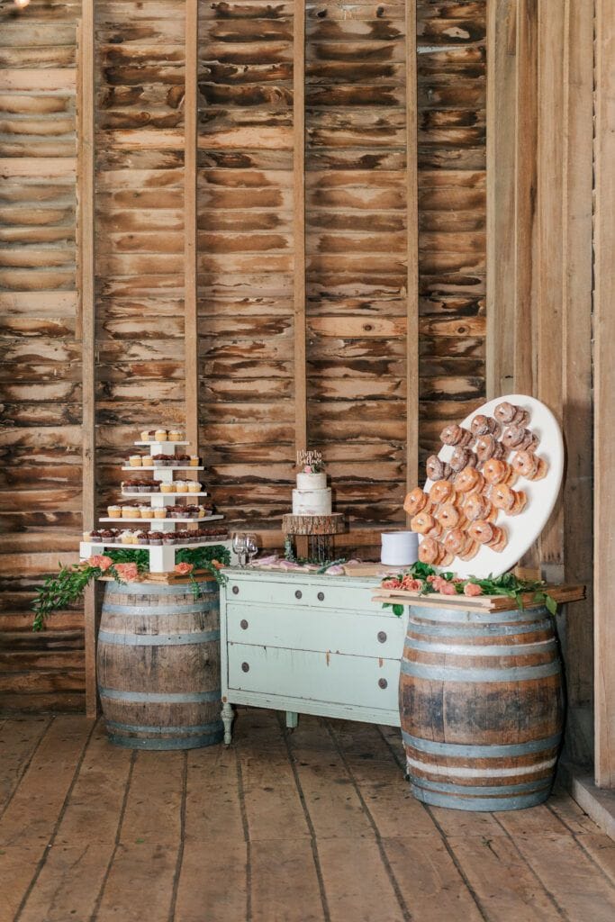Reception wedding cake and donut display at Sky Ridge Farm, a barn wedding venue in Waynesboro, VA, near the Blue Ridge Mountains. Photo by Wedding Phootography by Jo Mahaney, a Virginia wedding photographer.