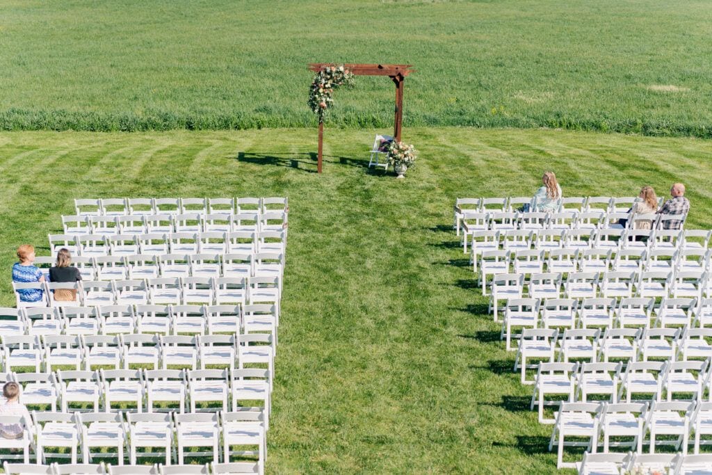 Aerial view of ceremony set up outdoors at Sky Ridge Farm, a barn wedding venue in Waynesboro, VA, near the Blue Ridge Mountains. Photo by Wedding Phootography by Jo Mahaney, a Virginia wedding photographer.