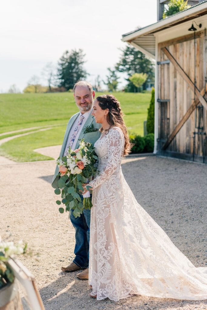 Father looks at his daughter before walking her down the aisle at her wedding at Sky Ridge Farm, a barn wedding venue in Waynesboro, VA, near the Blue Ridge Mountains. Photo by Wedding Phootography by Jo Mahaney, a Virginia wedding photographer.
