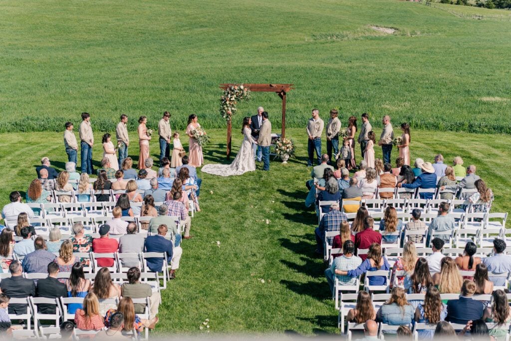 Ceremony view from the balcony at Sky Ridge Farm, a barn wedding venue in Waynesboro, VA, near the Blue Ridge Mountains. Photo by Wedding Phootography by Jo Mahaney, a Virginia wedding photographer.