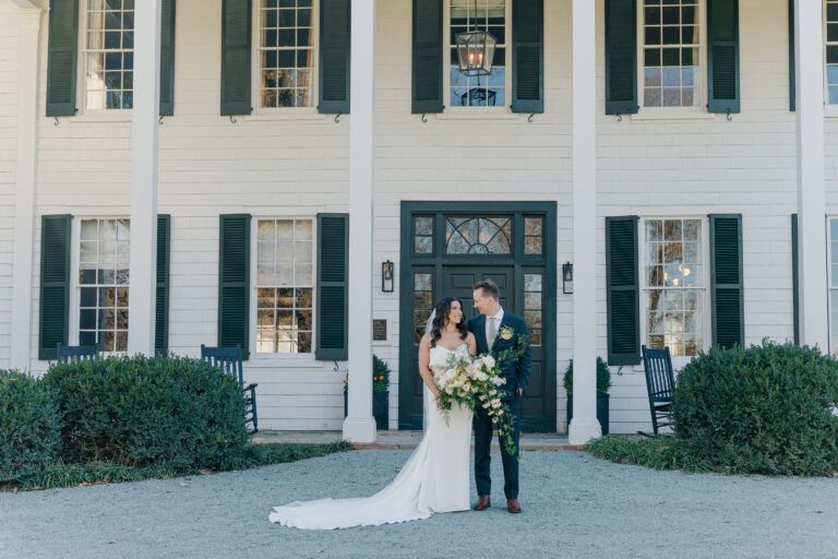 Newlywed couple poses for portraits in front of the historic Clifton Inn in Charlottesville VA