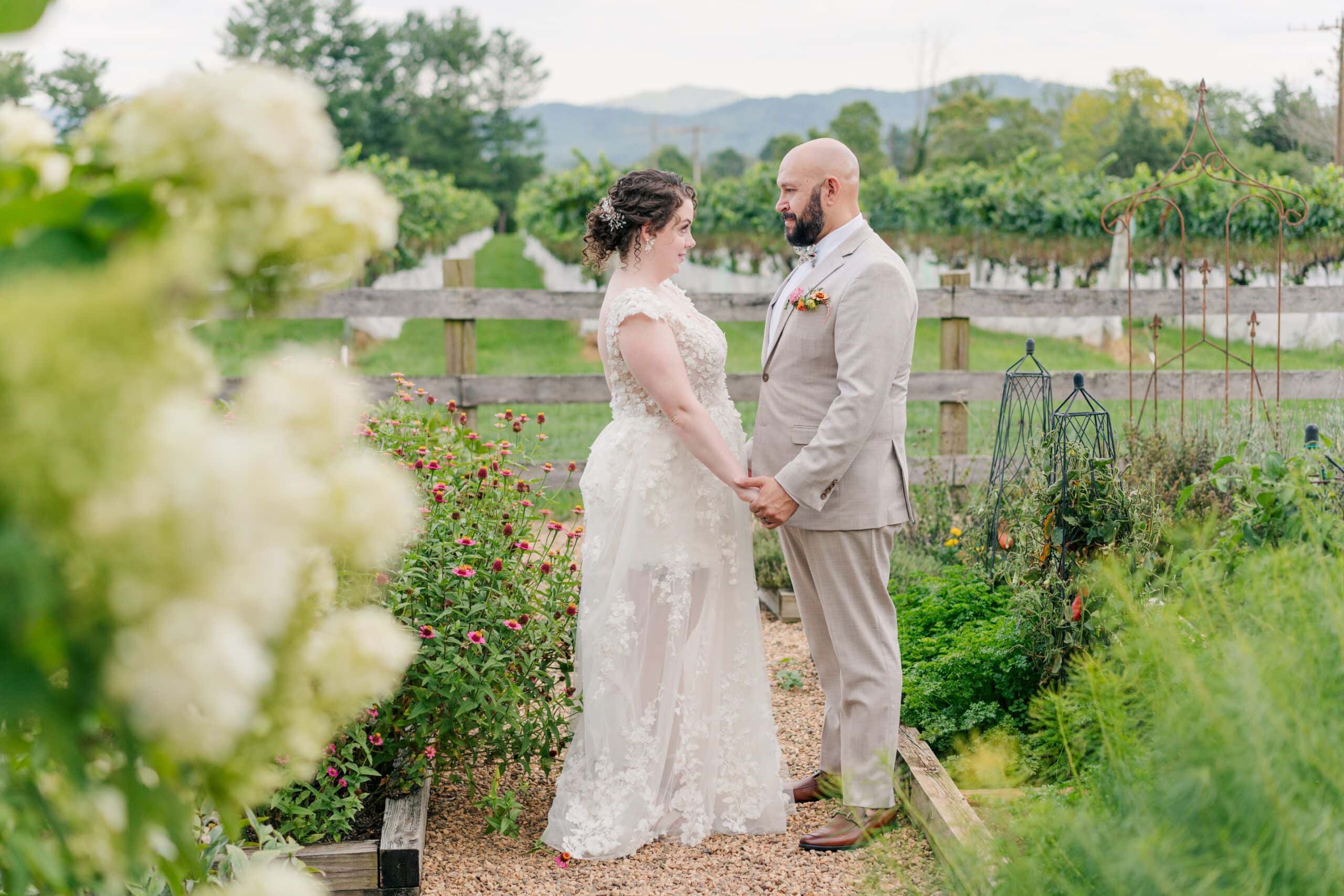 Newlywed couple stand in the gardens at Veritas winery enjoying golden hour photos after their wedding ceremony.